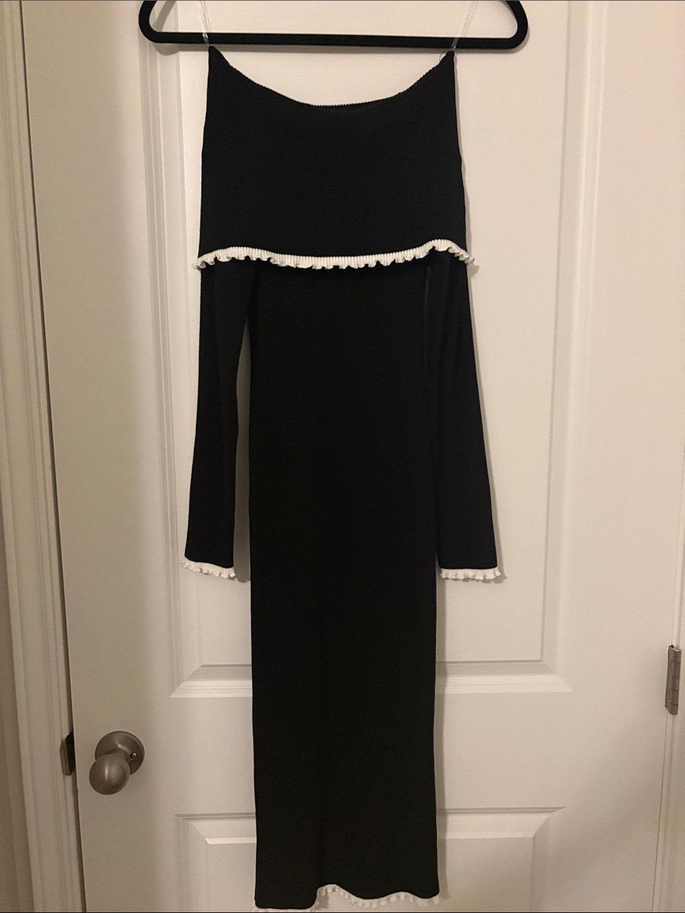 Better Be Black Ribbed Off shoulder sweater dress with scalloped white edges.